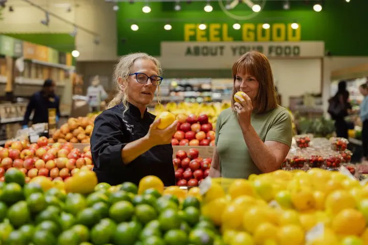 A PFC chef walking a guest through the produce section
