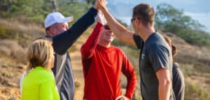 PFC weight loss participants high five each other outside after exercising