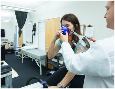 PFC doctor helps woman to boost wellness in a physical therapy room