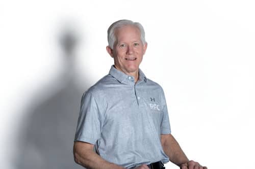PFC team member Jeff sits on stool