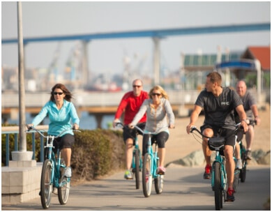 Weight loss camp participants bike together along the beach