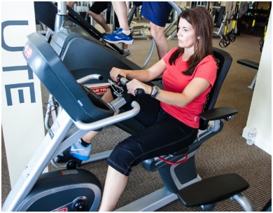 Woman on cycling machine at PFC's weight loss camp