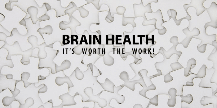 white puzzle pieces with black text "BRAIN HEALTH IT'S WORTH THE WORK" written above