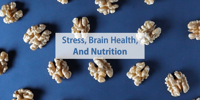 walnuts on blue table with "Stress, Brain Health, and Nutrition" written on top