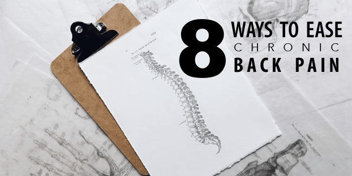 clipboard with spine diagram with "8 WAYS TO EASE CHRONIC BACK PAIN" next to it