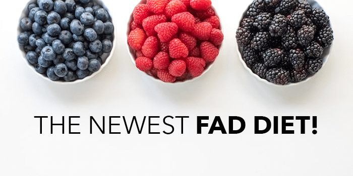 three bowls filled with blueberries, raspberries, and blackberries on table with "THE NEWEST FAD DIET!" written below