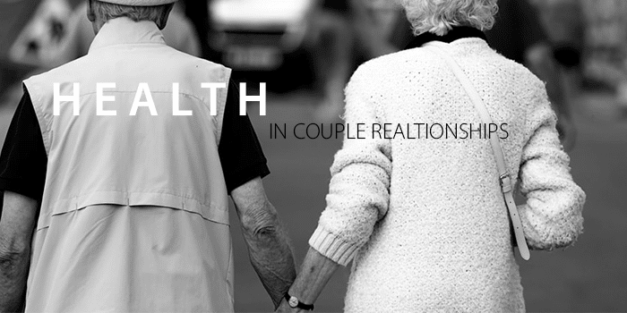 Couple holds hands with "HEALTH IN COUPLE RELATIONSHIPS" written in front of them