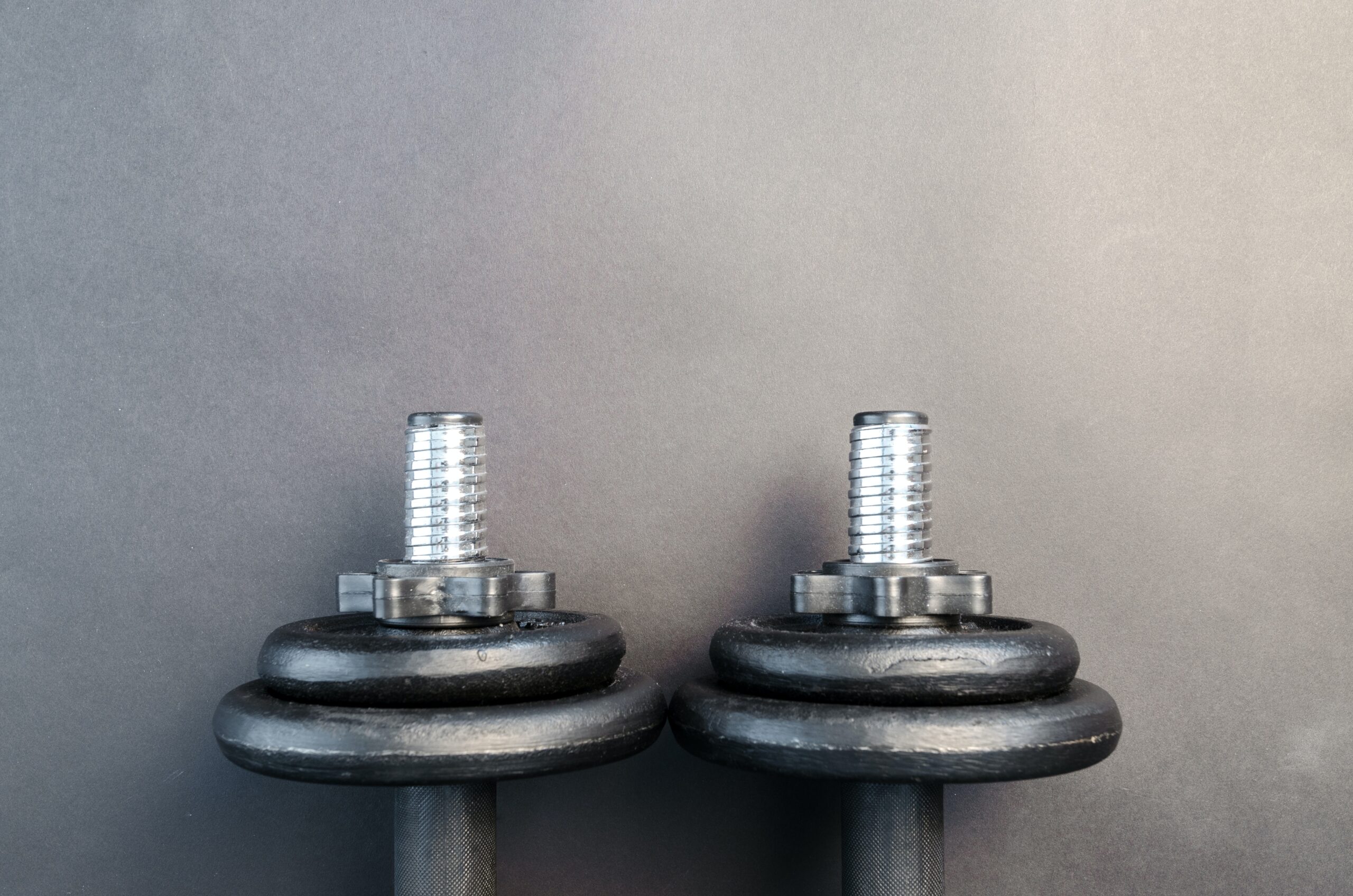 black and gray dumbbells against gray background