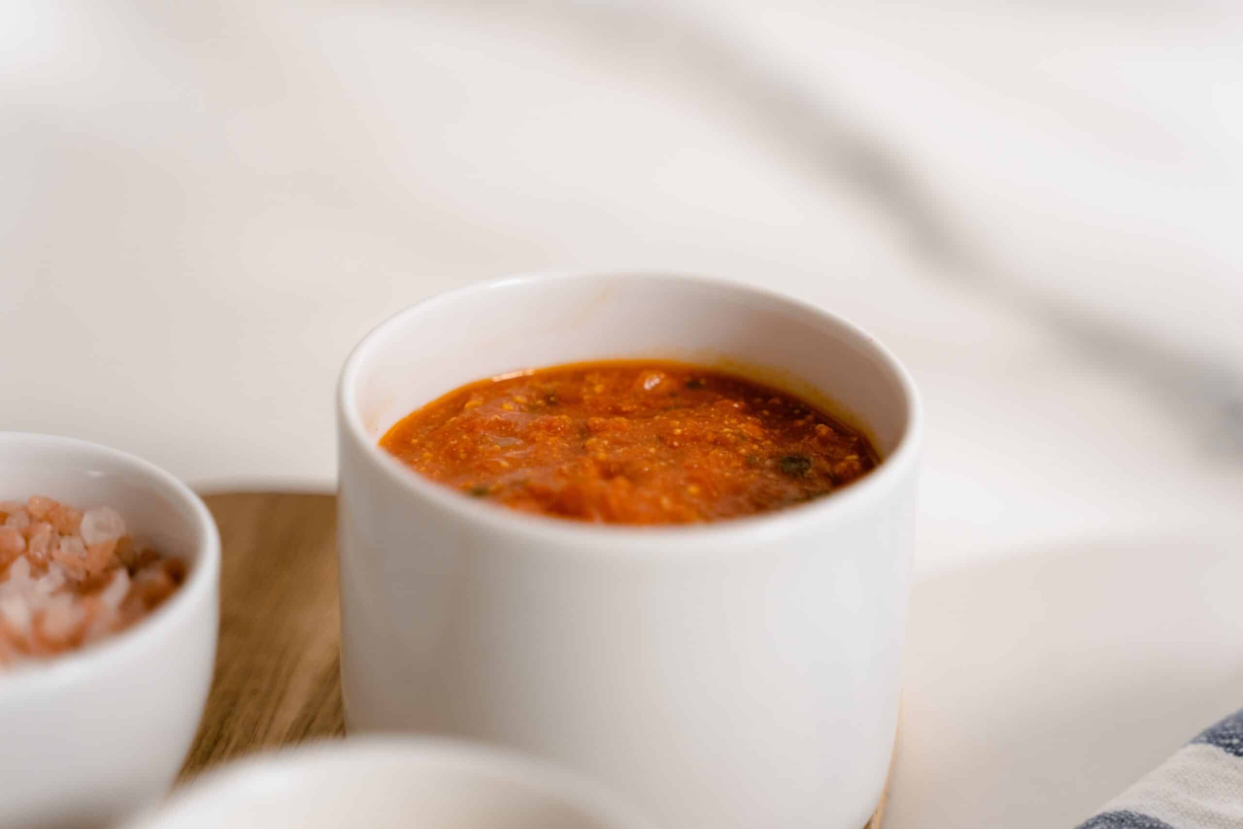 small bowl of marinara sauce on a table
