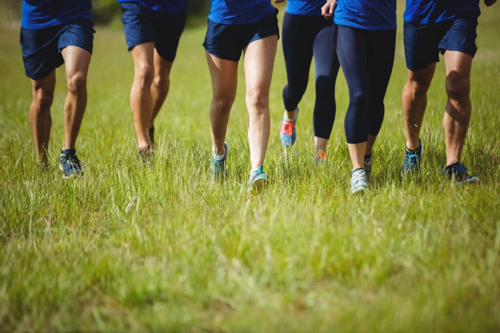 group of people running in a field to prepare for weight loss camp in california